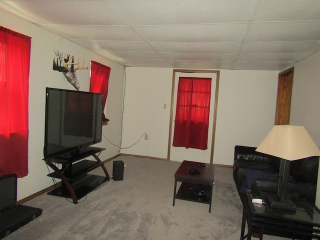 carpeted living room with a paneled ceiling