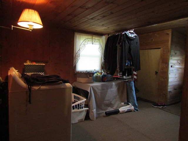 washroom featuring wood walls, carpet, and wooden ceiling