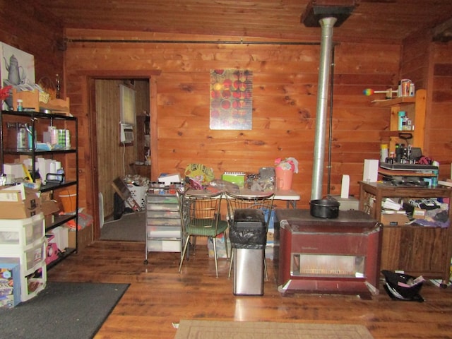 dining room with wood-type flooring and wood walls