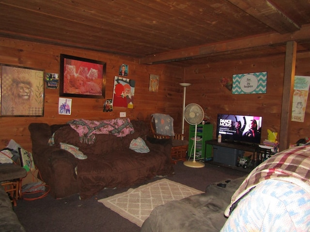 carpeted living room with beamed ceiling, wood ceiling, and wooden walls