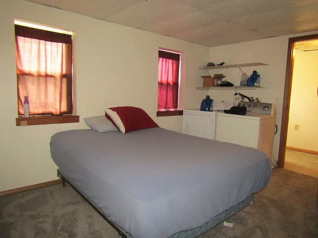 carpeted bedroom featuring separate washer and dryer