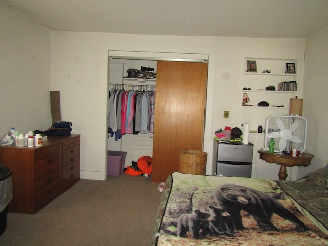 bedroom featuring carpet, stainless steel refrigerator, and a closet