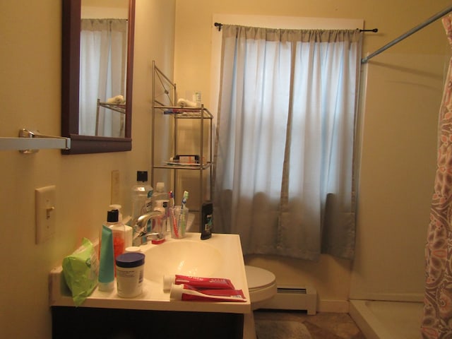 bathroom featuring a shower with shower curtain, vanity, toilet, and a baseboard heating unit