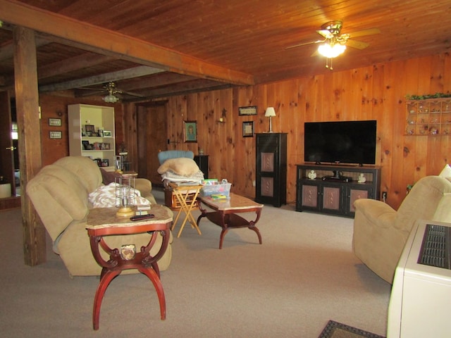 carpeted living room featuring beam ceiling, wooden walls, ceiling fan, and wooden ceiling