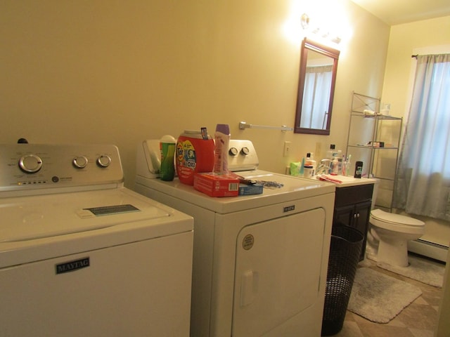 laundry room featuring light tile patterned flooring, washing machine and dryer, sink, and a baseboard heating unit