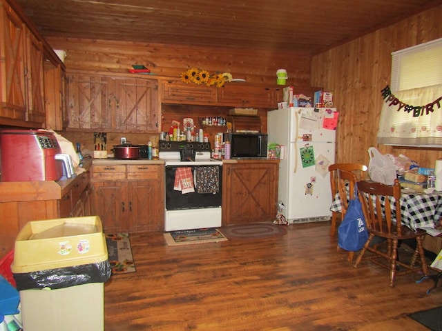 kitchen with dark hardwood / wood-style flooring, white appliances, wooden walls, and wooden ceiling