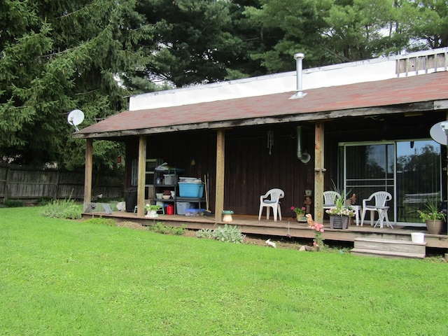 rear view of property featuring a lawn