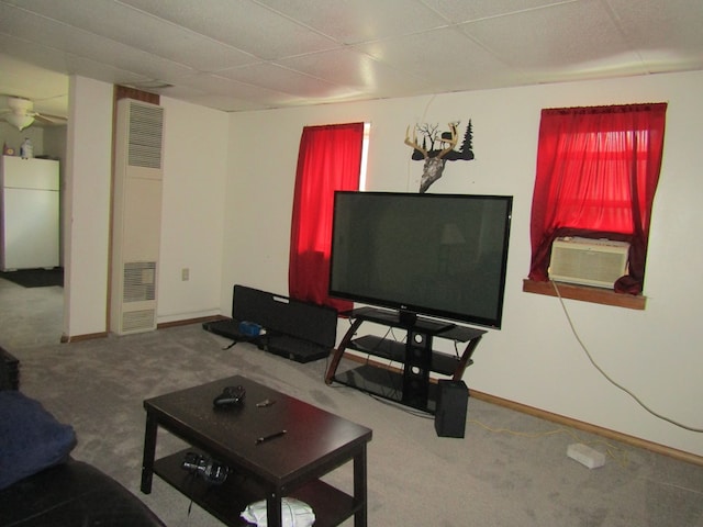 carpeted living room featuring a paneled ceiling and cooling unit