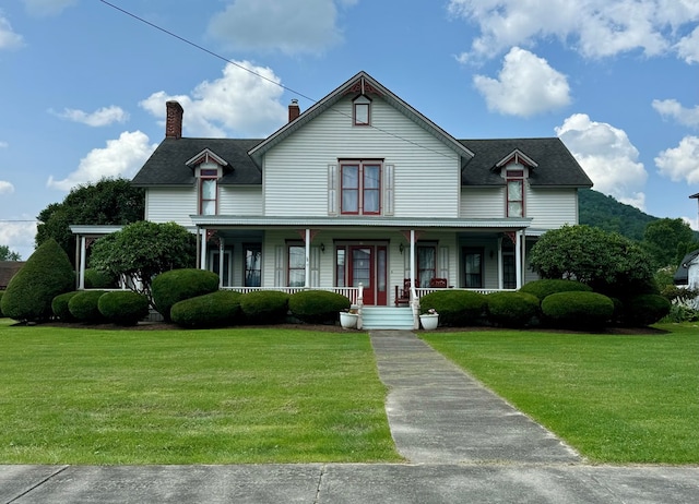 view of front of home featuring covered porch and a front yard