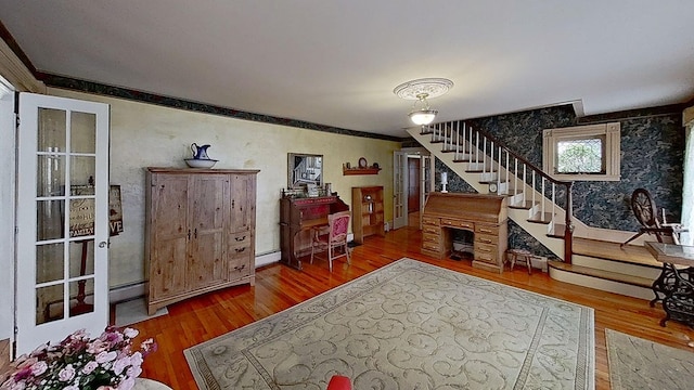 foyer with hardwood / wood-style floors and baseboard heating