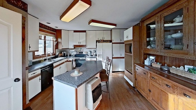 kitchen featuring stainless steel electric range oven, a center island, dishwasher, hardwood / wood-style floors, and white cabinets