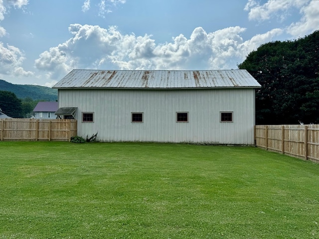 view of outbuilding with a yard