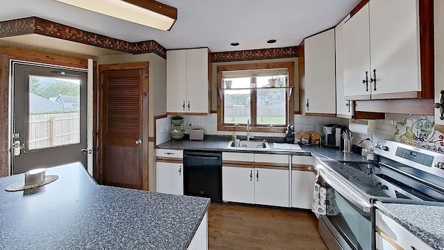 kitchen with sink, black dishwasher, white cabinetry, and electric stove