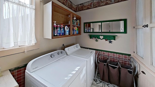 laundry room with washer and dryer and tile patterned floors