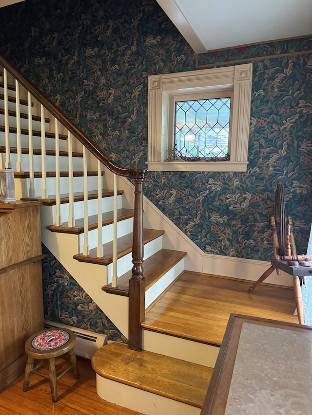 stairs featuring hardwood / wood-style floors