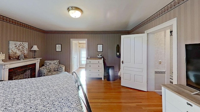 bedroom featuring light hardwood / wood-style floors and connected bathroom