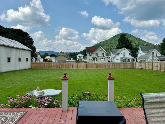 view of yard featuring a deck with mountain view