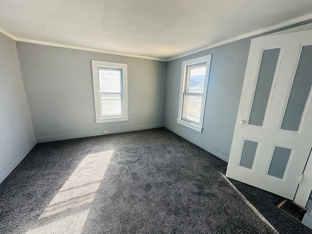 carpeted spare room with crown molding and a healthy amount of sunlight