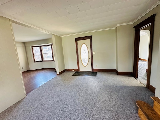 foyer with carpet and ornamental molding