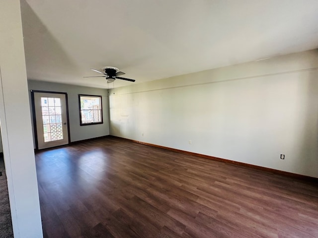 unfurnished room with dark hardwood / wood-style floors and ceiling fan