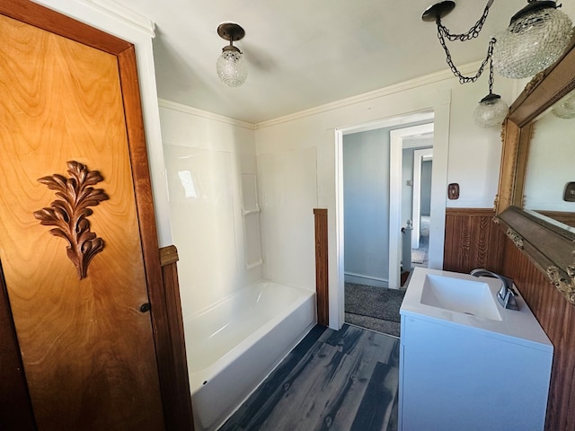 bathroom featuring vanity, hardwood / wood-style flooring, and crown molding