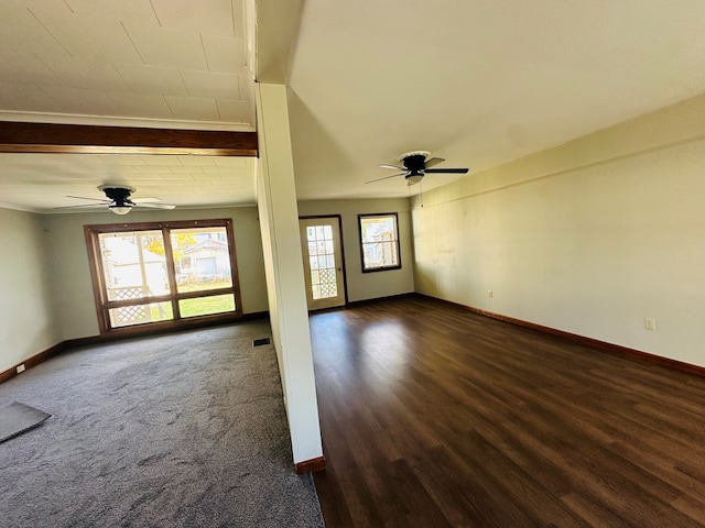 unfurnished living room featuring dark hardwood / wood-style floors, ceiling fan, and crown molding