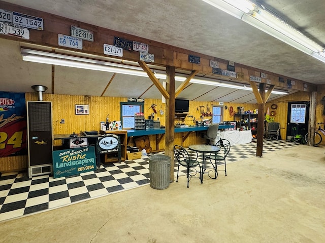 garage featuring wood walls and a workshop area