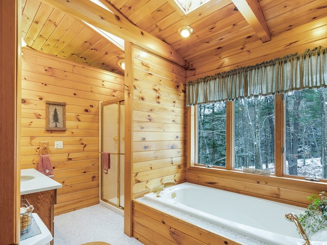 bathroom featuring shower with separate bathtub, wooden walls, vaulted ceiling with skylight, wood ceiling, and vanity