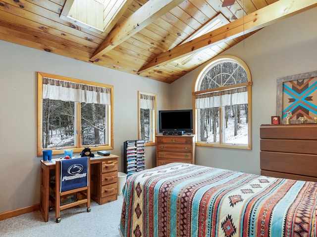 carpeted bedroom with vaulted ceiling with skylight and wood ceiling