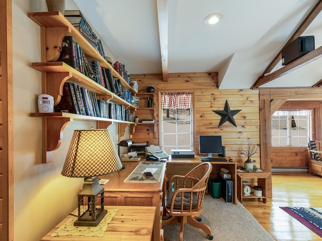 office with beamed ceiling, baseboard heating, wooden walls, and plenty of natural light