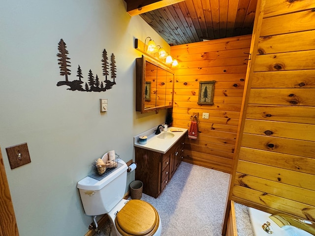 bathroom featuring toilet, wooden walls, vanity, and wood ceiling