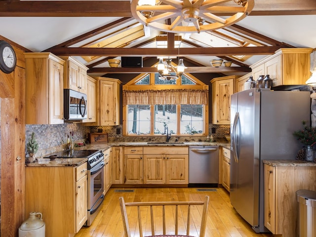 kitchen featuring sink, vaulted ceiling with beams, a notable chandelier, and appliances with stainless steel finishes