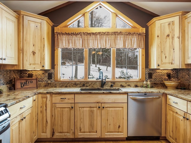 kitchen featuring stainless steel dishwasher, vaulted ceiling, tasteful backsplash, and sink