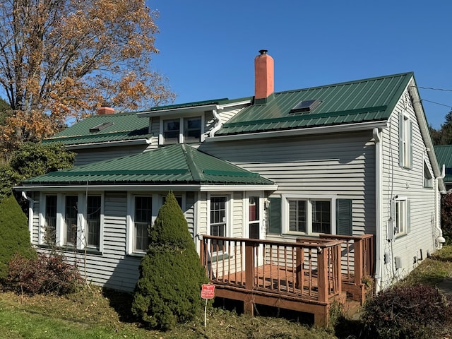 back of house with a deck