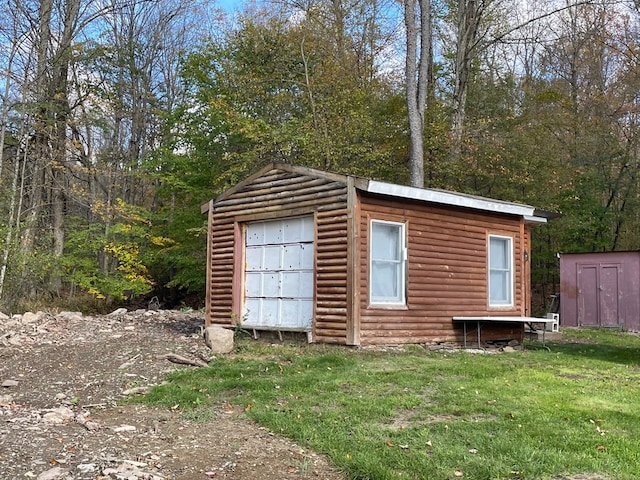 view of outdoor structure featuring a yard and a garage