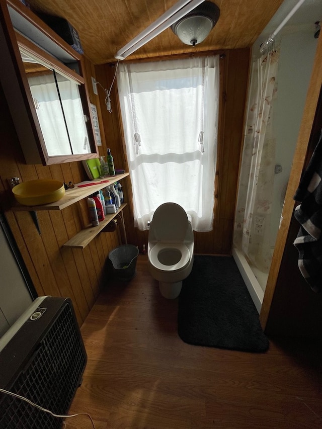 bathroom featuring hardwood / wood-style flooring, toilet, wooden walls, and wood ceiling