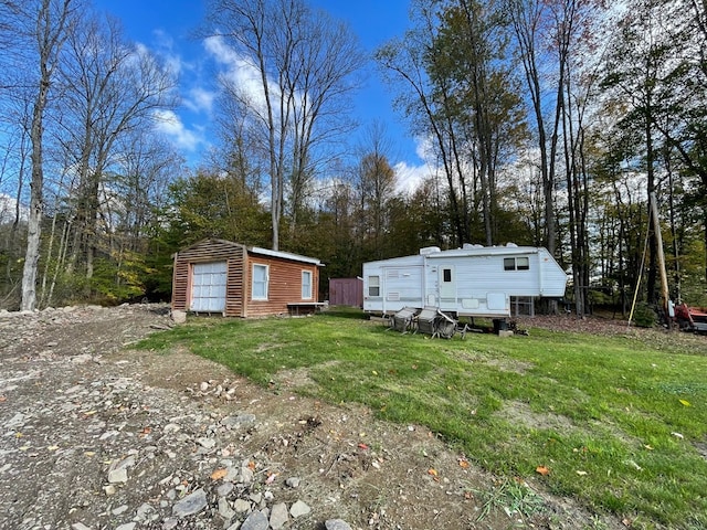 exterior space featuring an outbuilding and a lawn