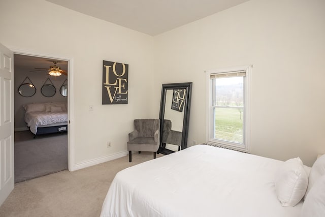 bedroom featuring light carpet and baseboards