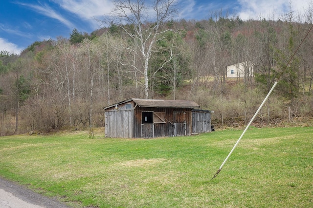 exterior space with a yard and a forest view