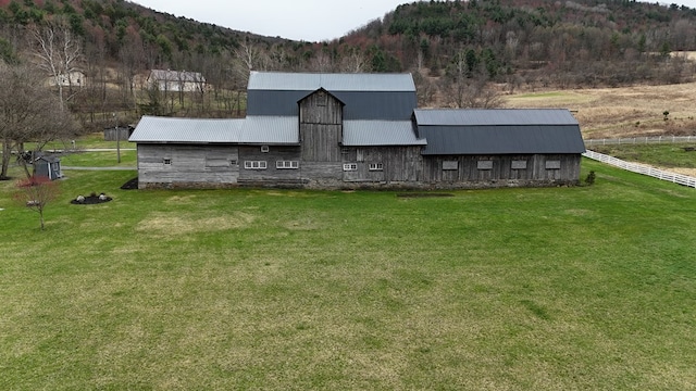 view of barn with a yard and a mountain view