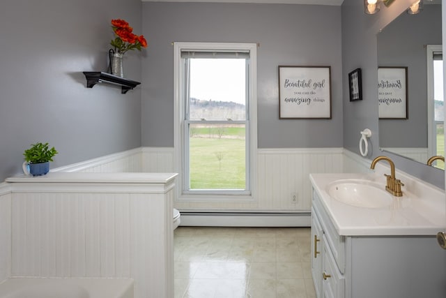 full bathroom featuring toilet, a wainscoted wall, vanity, and baseboard heating