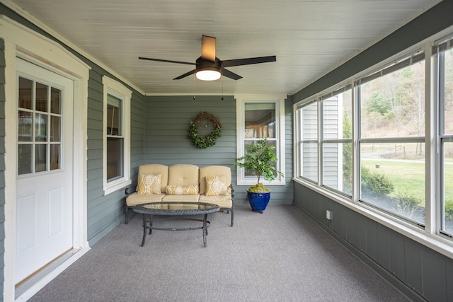 sunroom with a wealth of natural light and a ceiling fan