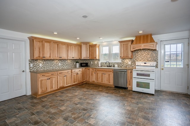 kitchen featuring stone finish floor, double oven range, custom exhaust hood, dishwasher, and a sink