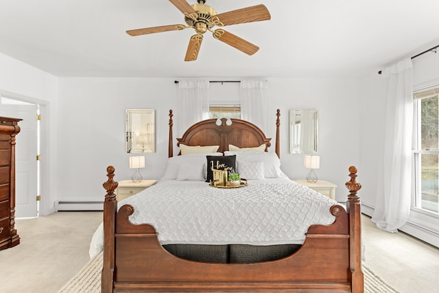 bedroom featuring baseboard heating, light carpet, and a ceiling fan