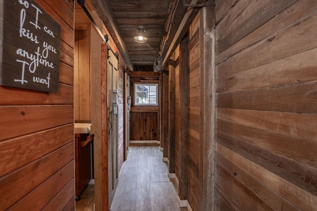 hall with wooden walls and wood finished floors