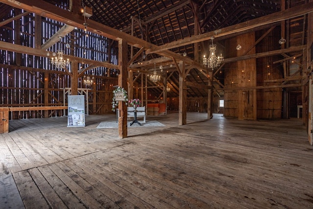 miscellaneous room with hardwood / wood-style floors and a notable chandelier