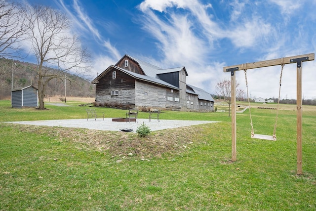 view of yard featuring a barn and an outdoor structure