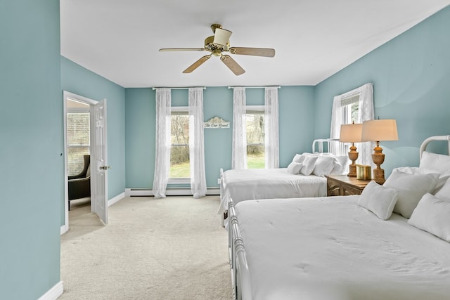 bedroom featuring baseboards, ceiling fan, a baseboard heating unit, and light carpet