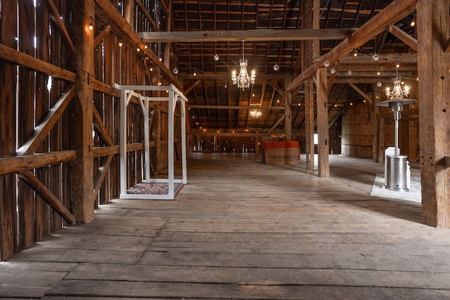 misc room with wood-type flooring and a notable chandelier