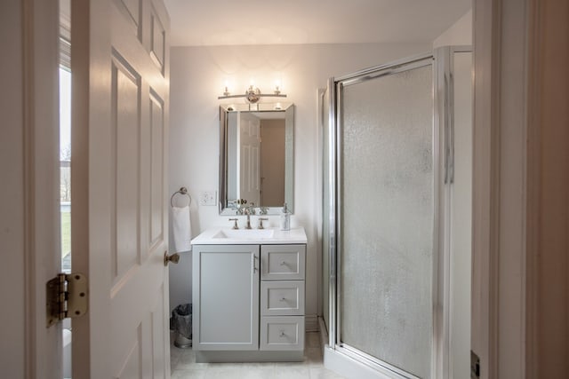 full bathroom with a stall shower, vanity, and tile patterned flooring